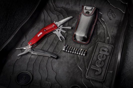Multitool with sheath on a Jeep branded car mat